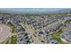 Expansive aerial view showcases a well-planned community with homes, green spaces, and scenic surroundings at 18085 E 107Th Pl, Commerce City, CO 80022