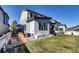 Spacious backyard with manicured lawn, slide, and a patio, perfect for outdoor activities at 18085 E 107Th Pl, Commerce City, CO 80022