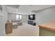 Relaxing basement area with a comfortable sectional couch, entertainment center, and neutral-toned carpet at 18085 E 107Th Pl, Commerce City, CO 80022