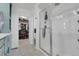 Modern bathroom featuring a glass walk-in shower and a view into the walk-in closet at 18085 E 107Th Pl, Commerce City, CO 80022