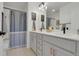 Bathroom with double vanity, framed mirrors and modern fixtures at 18085 E 107Th Pl, Commerce City, CO 80022