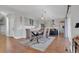 Open-concept dining area flowing into the kitchen, featuring modern lighting and hardwood floors at 18085 E 107Th Pl, Commerce City, CO 80022