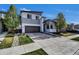 Modern two-story home featuring a well-manicured lawn and a convenient two-car garage at 18085 E 107Th Pl, Commerce City, CO 80022