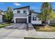 Modern two-story home with two-car garage, concrete driveway, and manicured landscaping at 18085 E 107Th Pl, Commerce City, CO 80022