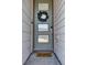 Welcoming front door with glass panels, a leafy wreath, and a 'hello' doormat at 18085 E 107Th Pl, Commerce City, CO 80022