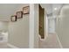 Basement hallway with neutral paint, carpet, and unique decorative art on the walls at 18085 E 107Th Pl, Commerce City, CO 80022