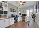 Bright home office with built-in desks, shelving, and large windows for natural light at 18085 E 107Th Pl, Commerce City, CO 80022