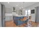 Open concept kitchen with island, gray cabinets, stainless appliances, and pendant lights at 18085 E 107Th Pl, Commerce City, CO 80022