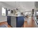 Open concept kitchen with island flows into the dining and living spaces at 18085 E 107Th Pl, Commerce City, CO 80022