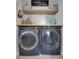 Efficient laundry room featuring modern, front-loading washer and dryer with open shelving at 18085 E 107Th Pl, Commerce City, CO 80022