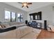 Bright living room with a comfortable couch, large windows, and an entertainment center at 18085 E 107Th Pl, Commerce City, CO 80022