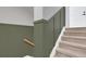 Carpeted staircase with decorative wainscoting and a wooden handrail at 18085 E 107Th Pl, Commerce City, CO 80022