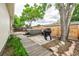 Backyard featuring a hot tub, barbecue, and wooden pathway, perfect for outdoor enjoyment at 5532 Umatilla St, Denver, CO 80221