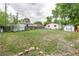 Large backyard featuring mature trees and a storage shed, offering ample outdoor space at 5532 Umatilla St, Denver, CO 80221