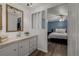 Bathroom with a bedroom view, white vanity and modern fixtures at 5532 Umatilla St, Denver, CO 80221