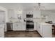 Bright, updated kitchen featuring stainless steel appliances and ample counter space at 5532 Umatilla St, Denver, CO 80221