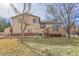 View of backyard with wooden fence, deck, and mature trees at 9359 W Lake Dr, Littleton, CO 80123