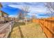 Backyard has a wooden fence, grass, and a mature tree at 9359 W Lake Dr, Littleton, CO 80123