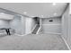 Finished basement showcasing gray walls, carpet, and a staircase leading upstairs at 9359 W Lake Dr, Littleton, CO 80123