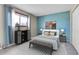 Main bedroom with light blue accent wall and comfortable bed at 9359 W Lake Dr, Littleton, CO 80123