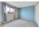 Carpeted bedroom with neutral paint, large window, and closet at 9359 W Lake Dr, Littleton, CO 80123