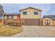 Two-story house with a brown garage door and wooden deck at 9359 W Lake Dr, Littleton, CO 80123