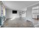 Neutral living room with tile floors, window and view to kitchen at 9359 W Lake Dr, Littleton, CO 80123