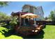 Deck with pergola, table, chairs, and surrounding greenery at 2834 S Fig St, Lakewood, CO 80228