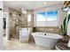 Luxurious bathroom with soaking tub, walk-in shower, and modern finishes at 2834 S Fig St, Lakewood, CO 80228