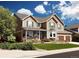 Two-story house with landscaped yard, attached garage, and inviting front porch at 2834 S Fig St, Lakewood, CO 80228