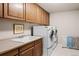 Laundry room with washer, dryer, and utility sink at 2834 S Fig St, Lakewood, CO 80228