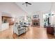 Open living room with vaulted ceiling, fireplace, and hardwood floors at 2834 S Fig St, Lakewood, CO 80228