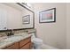 Convenient powder room with granite countertop and updated fixtures at 2834 S Fig St, Lakewood, CO 80228