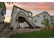 Exterior view of a two-story home with elevated deck, staircase and patio with furniture and landscaped backyard at 1607 Goldfield Trl, Castle Rock, CO 80109