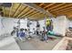 Unfinished basement with exercise equipment, punching bag, grey flooring and exposed ceiling at 1607 Goldfield Trl, Castle Rock, CO 80109