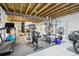 Unfinished basement with exercise equipment, punching bag, grey flooring, and a treadmill at 1607 Goldfield Trl, Castle Rock, CO 80109
