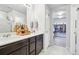 Bathroom featuring double sinks, granite countertops, and an adjacent walk-in closet at 1607 Goldfield Trl, Castle Rock, CO 80109