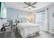 Comfortable bedroom with soft blue walls, a plush bed, and ample natural light from a bright window at 1607 Goldfield Trl, Castle Rock, CO 80109