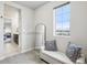 Spacious walk-in closet featuring a cushioned bench, large mirror, and a sunny window, offering comfort and style at 1607 Goldfield Trl, Castle Rock, CO 80109
