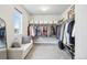 Walk-in closet with ample storage, white shelving, and comfortable seating next to a bright window at 1607 Goldfield Trl, Castle Rock, CO 80109