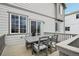 Outdoor deck with seating, grey table, grey chairs, and views of the neighborhood at 1607 Goldfield Trl, Castle Rock, CO 80109