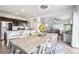 Open-concept dining area with modern chandelier adjacent to the kitchen and living room, filled with natural light at 1607 Goldfield Trl, Castle Rock, CO 80109