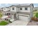 Charming two-story home featuring a covered front porch, a two car garage and solar panels at 1607 Goldfield Trl, Castle Rock, CO 80109