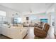 Spacious living room featuring hardwood floors, a ceiling fan, comfortable seating and a large picture window at 1607 Goldfield Trl, Castle Rock, CO 80109