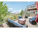 Outdoor patio with comfortable seating, green grass, and a second story deck at 1607 Goldfield Trl, Castle Rock, CO 80109