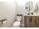 Stylish powder room with a modern vanity, decorative mirror, and a fresh, minimalist design at 957 Rosedale St, Castle Rock, CO 80104