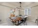Bright dining room with a modern light fixture and a rustic wooden table at 957 Rosedale St, Castle Rock, CO 80104