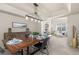 Elegant dining room featuring a rustic wood table, contemporary lighting, and an open floor plan at 957 Rosedale St, Castle Rock, CO 80104