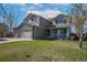 Charming two-story home with a stone facade and a welcoming front porch and well-manicured lawn at 957 Rosedale St, Castle Rock, CO 80104