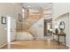 Inviting foyer with a wooden staircase and views into other rooms at 957 Rosedale St, Castle Rock, CO 80104